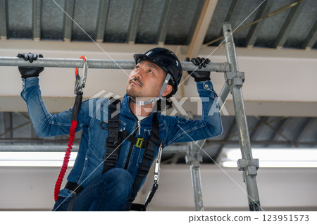 A man performing inspection work at a height A man performing inspection work at a height 123951573