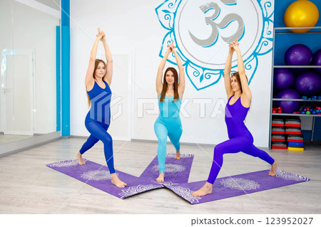 Standing vertical yoga pose on the mat with a forward lunge 123952027