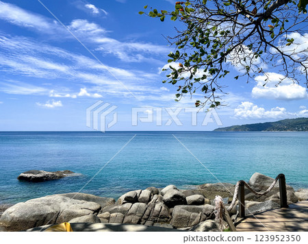 Tropical Beach Paradise with Crystal Clear Water and Rocky Shoreline in Phuket, Thailand 123952350