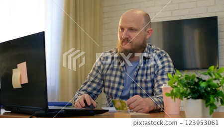 Modern man adapting to business trends, modernity evident in stylish home office, modernity driving professional success, modernity shaping future work culture, perfect for corporate videos. Modern man adapting to business trends, modernity evident in stylish home office, modernity driving professional success, modernity shaping future work culture, perfect for corporate videos. 123953061