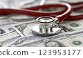 Stethoscope and coins on a document representing healthcare expenses. Financial and medical concept 123953177