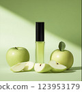 Green apple-inspired perfume with fresh apples on a green background. Fragrance and nature concept 123953179