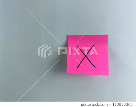 Sticky note on white background with cross Sticky note on white background with cross 123953303