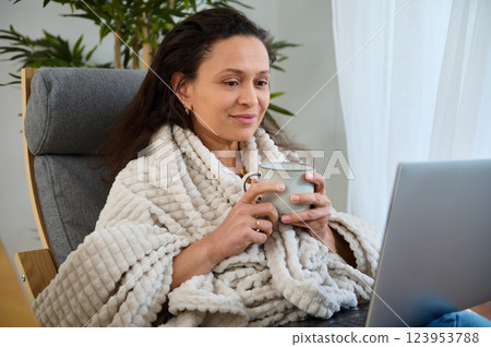 Cozy Work from Home Setup with Woman Enjoying a Beverage 123953788