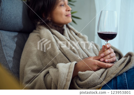 Cozy Woman Relaxing Indoors with Wine, Embracing Tranquility and Comfort Cozy Woman Relaxing Indoors with Wine, Embracing Tranquility and Comfort 123953801