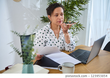 Freelance Designer Working Remotely From Home Using Laptop and Smartphone 123953854