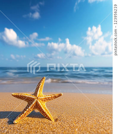 A vibrant yellow starfish with white spots rests on a sandy beach under a bright blue sky with scattered clouds and sunlight. A vibrant yellow starfish with white spots rests on a sandy beach under a bright blue sky with scattered clouds and sunlight. 123956219
