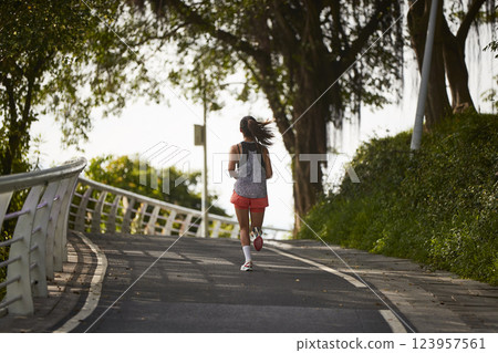 young asian woman jogging running in park young asian woman jogging running in park 123957561