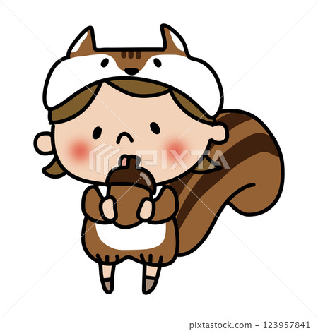 A child dressed as a squirrel holding an acorn 123957841