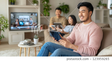 Enjoying technology in cozy living room with family and friends Enjoying technology in cozy living room with family and friends 123959265