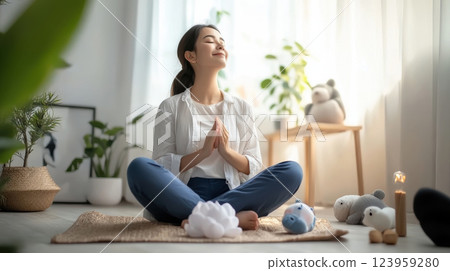 woman meditating peacefully in serene indoor space with soft lighting 123959280