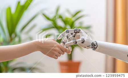 robotic hand reaching out to touch human hand in lush environment 123959475