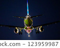 A plane landing with runway lights reflected on its fuselage 123959987