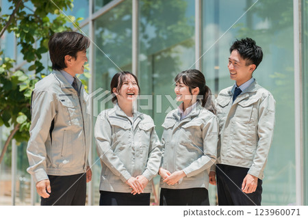 Male and female staff in the manufacturing, building, transportation, and construction industries wearing work clothes. 123960071