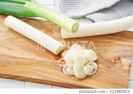 Finely chopped green onions on a cutting board Finely chopped green onions on a cutting board 123960923