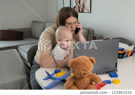 A busy parent balancing work demands with effective childcare management at home 123961038