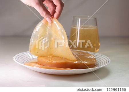 A guide to preparing fermented Kombucha and cultivating your own SCOBY for brewing 123961166