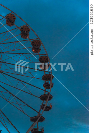 Ferris Wheel Illuminated at Night in Front of Erfurt Cathedral with Warm Lights and Dark Evening Sky. High quality photo 123961650