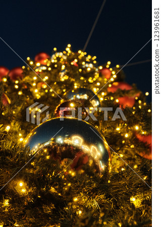 Golden Christmas tree adorned with glowing lights and ornaments in a festive evening setting. High quality photo Golden Christmas tree adorned with glowing lights and ornaments in a festive evening setting. High quality photo 123961681