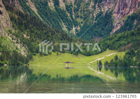 Konigssee Lake in Bavaria Germany with Church by the Lake White Boat Forested Mountain and Beautiful Sunny Trekking in Berchtesgaden German Alps. High quality photo Konigssee Lake in Bavaria Germany with Church by the Lake White Boat Forested Mountain and Beautiful Sunny Trekking in Berchtesgaden German Alps. High quality photo 123961705