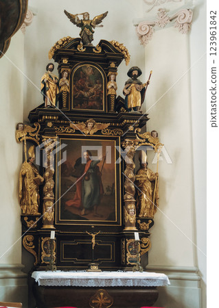 Scenic view of a charming lakeside village featuring a historic church, surrounded by majestic mountains. Tourists enjoy the tranquil atmosphere and beautiful architecture in Konigsse lake Bavaria 123961842