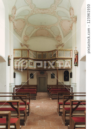 Scenic view of a charming lakeside village featuring a historic church, surrounded by majestic mountains. Tourists enjoy the tranquil atmosphere and beautiful architecture in Konigsse lake Bavaria 123961930