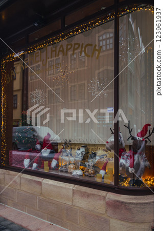 festive shop window display with decorative lights and holiday ornaments during christmas season. High quality photo 123961937