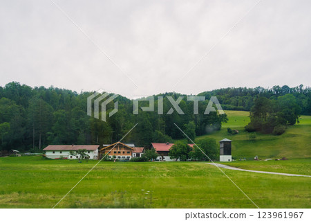 Scenic countryside view featuring traditional buildings surrounded by lush greenery in a tranquil rural setting Konigssee Bavaria German Apls. High quality photo Scenic countryside view featuring traditional buildings surrounded by lush greenery in a tranquil rural setting Konigssee Bavaria German Apls. High quality photo 123961967