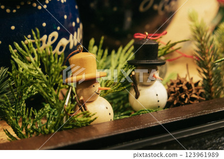 Delightful snowman ornaments beautifully arranged on a pine tree, radiating the joyous spirit of the holiday season Delightful snowman ornaments beautifully arranged on a pine tree, radiating the joyous spirit of the holiday season 123961989