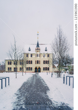 A picturesque snowy road gracefully winding through a charming little village during the magical winter season A picturesque snowy road gracefully winding through a charming little village during the magical winter season 123961990