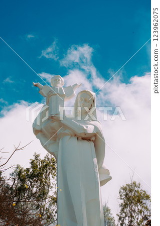 Vung Tau Beach with Blue Sky Flowers and Mother Mary Statue Scenic Coastal View with Coffee Shop Nearby High quality photo 123962075