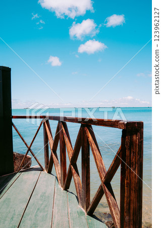 Vung Tau Beach with Blue Sky Flowers and Mother Mary Statue Scenic Coastal View with Coffee Shop Nearby High quality photo 123962127