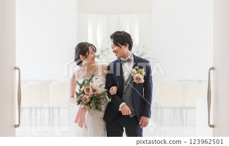 Bride and groom walking in the wedding hall (virgin road, church, chapel) Bride and groom walking in the wedding hall (virgin road, church, chapel) 123962501