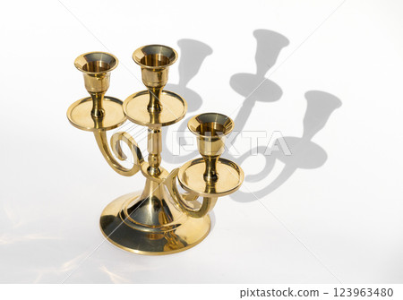 Golden candlestick on a white background Golden candlestick on a white background 123963480