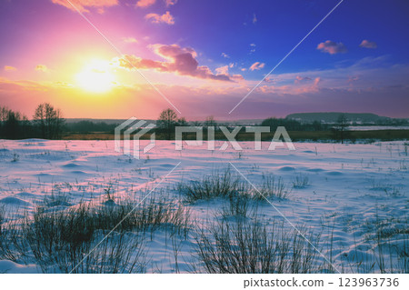 Winter snowy landscape. Snow-covered field at sunset 123963736