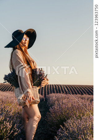 Woman in a Lavender Field Holding a Basket of Flowers Woman in a Lavender Field Holding a Basket of Flowers 123963750