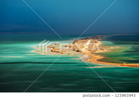Seascape in the morning at dramatic light. Small island in the Dead Sea. View of Jordan from Israel Seascape in the morning at dramatic light. Small island in the Dead Sea. View of Jordan from Israel 123963943