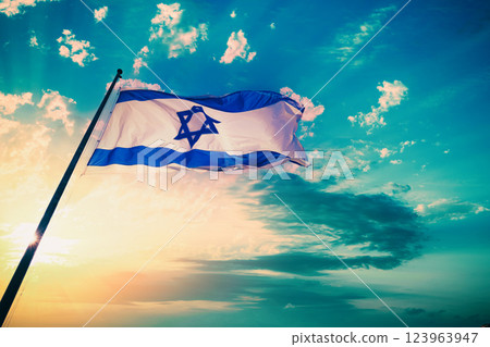 Flag of Israel fluttering against sunset sky 123963947