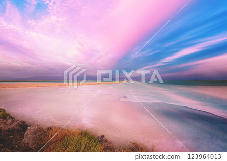Seascape in the morning. Pink sunrise over the Dead Sea. View of Jordan from Israel Seascape in the morning. Pink sunrise over the Dead Sea. View of Jordan from Israel 123964013