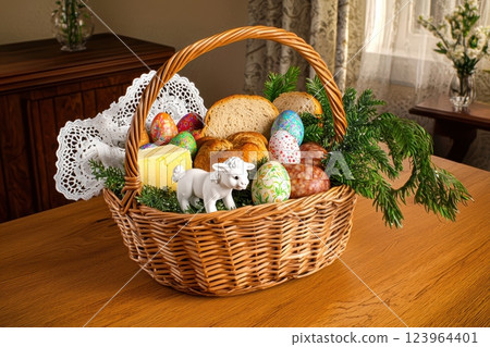 An elaborately designed Easter Basket filled with Colorful Eggs and various Decorative Items 123964401