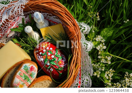 A delightful Easter picnic basket filled with traditional food items and festive decor 123964438