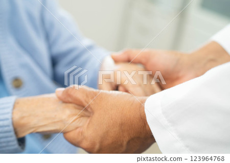 Doctor holding hands Asian elderly woman patient, help and care in hospital. 123964768