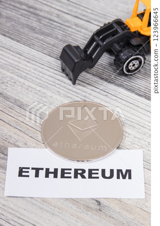 Ethereum and miniature excavator. Cryptocurrency. International network payment. Finance concept 123966645