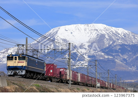 Snow-capped Mt. Ibuki and an EF65 freight train running on the Tokaido Line 123967375