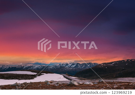 Scandinavia. Amazing Scenic View Of Norwegian Mountains. Scenic Mountain Route Road In Autumn Day. Bright Magenta Cloudy Sky Above Norwegian Scenic Landscape. Scandinavia. Amazing Scenic View Of Norwegian Mountains. Scenic Mountain Route Road In Autumn Day. Bright Magenta Cloudy Sky Above Norwegian Scenic Landscape. 123969219