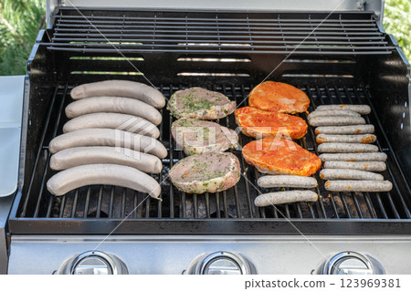 Barbecue grill bbq on propane gas grill steaks bratwurst sausages meat meal 123969381