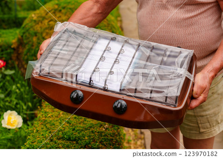 The hands of an elderly man with packed a new gas stove. 123970182