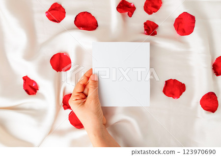Top view of hand holding an empty note Top view of hand holding an empty note 123970690