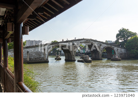Traditional arched Gongchen Bridge in Hangzhou, China 123971040