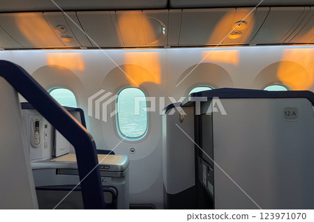 Comfortable business class seats and window light Comfortable business class seats and window light 123971070
